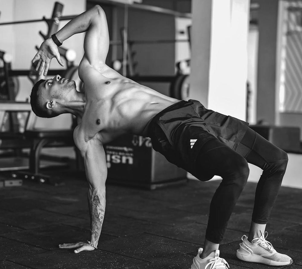 Sanchit performing a mobility flow on the gym floor